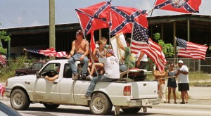 Protesters display Confederate flags United States flags from the bed of a pickup truck May 6 on a highway about 15 miles south of Miami in what organizers said was a protest to show support for Attorney General Janet Reno and respect for the flag. Organizers said they wanted to counteract demonstrations held by members of the Cuban-American community that followed the April 22 seizure of Cuban rafter Elian Gonzalez by government agents from the home of his Miami relatives. BC/CLH/